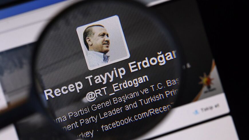 An image of Turkish Prime Minister Tayyip Erdogan on a twitter account is pictured through a magnifying glass in this illustration picture taken in Istanbul March 21, 2014. Turkey's courts have blocked access to Twitter days before elections as Prime Minister Tayyip Erdogan battles a corruption scandal that has seen social media platforms awash with alleged evidence of government wrongdoing. The ban came hours after a defiant Erdogan, on the campaign trail ahead of key March 30 local elections, vowed to "wi