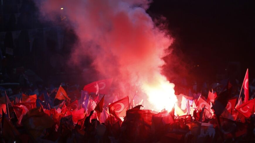Supporters of Turkey's Prime Minister Tayyip Erdogan light flares during an election rally in Istanbul March 23, 2014. Erdogan, rallying hundreds of thousands of cheering supporters in Istanbul, said on Sunday that political enemies accusing him of corruption would be crushed by their own immorality. REUTERS/Murad Sezer (TURKEY - Tags: POLITICS ELECTIONS) - RTR3I986