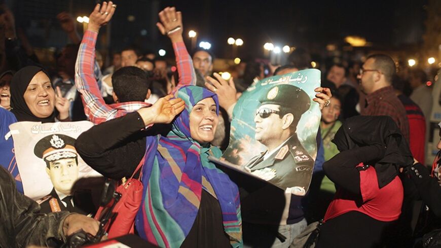 People celebrate after Egypt's army chief Field Marshal Abdel Fattah al-Sisi declared his candidacy for a presidential election, in Tahrir square in Cairo March 26, 2014. Al-Sisi, the general who ousted Egypt's first freely elected leader, on Wednesday declared his candidacy for a presidential election he is expected to win easily. REUTERS/Asmaa Waguih (EGYPT - Tags: POLITICS ELECTIONS MILITARY) - RTR3IQR0