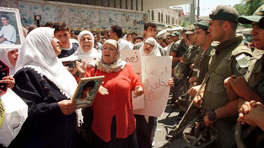 Israeli Border Policemen keep watch over several dozen Palestinians demonstrating in Jerusalem June 28. Palestinian women chanting slogans and holding pictures of their sons demonstrated in Arab East Jerusalem calling for Israel to free their relatives who are being held as political prisoners. More than 5,000 Palestinians prisoners are held in Israeli jails.
MIDEAST - RTR4VBH