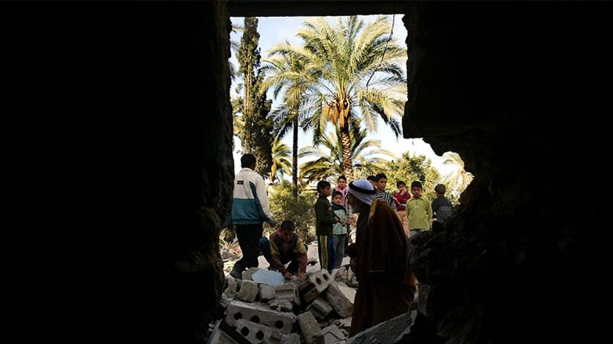 Palestinians check the damage to their house in the Khan Younis refugee
camp, south of the Gaza strip January 1, 2003. Overnight 10 Israeli
tanks and armoured personnel carriers were involved in the operation to
blow up the house of Yassin al-Agha, who was killed by Israeli troops
last month. Palestinians and human rights groups call Israel's house
demolition policy a form of "collective punishment" that violates
international humanitarian law. REUTERS/Ahmed Jadallah

AJ/JDP - RTRFZES