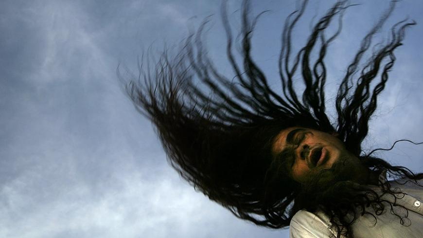 An Iraqi Dervish prays during a gathering outside their Tekiyah, a place of worship, in Baghdad, May 29, 2003. Swaying gently at first, chanting in monotones, the Dervishes slowly build up to a frenzy of prayers. Dervishes are Sufis, a spiritual offshoot of Islam, who believe their bodies open up to the energy of God when they are in prayer. Pictures of the month May 2003 NO RIGHTS CLEARANCES OR PERMISSIONS ARE REQUIRED FOR THIS IMAGE REUTERS/Damir Sagolj PP05080023 JD/CRB - RTROHMO