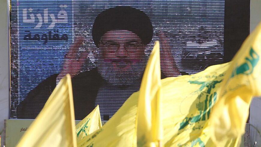 Lebanon's Hezbollah leader Sayyed Hassan Nasrallah addresses his supporters via a screen during a rally on the 7th anniversary of the end of Hezbollah's 2006 war with Israel, in Aita al-Shaab village in southern Lebanon, August 16, 2013. Nasrallah renewed his commitment on Friday to the battle in Syria, where the Shi'ite militant group has been fighting alongside President Bashar al-Assad's forces, saying he was ready to go himself if needed. REUTERS/Ali Hashisho (LEBANON - Tags: POLITICS CIVIL UNREST AN