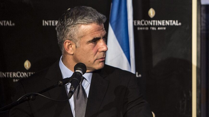 Secretary-General of the Organisation for Economic Co-operation and Development (OECD) Jose Angel Gurria (R) speaks during a news conference with Israel's Finance Minister Yair Lapid in Tel Aviv December 8, 2013. Gurria was in Israel on Sunday to present the organisation's 2013 report on Israel's economy. The Bank of Israel should prepare for interest rate increases once the global economy returns to normal, the OECD said. REUTERS/ Nir Elias (ISRAEL - Tags: POLITICS BUSINESS) - RTX169RU
