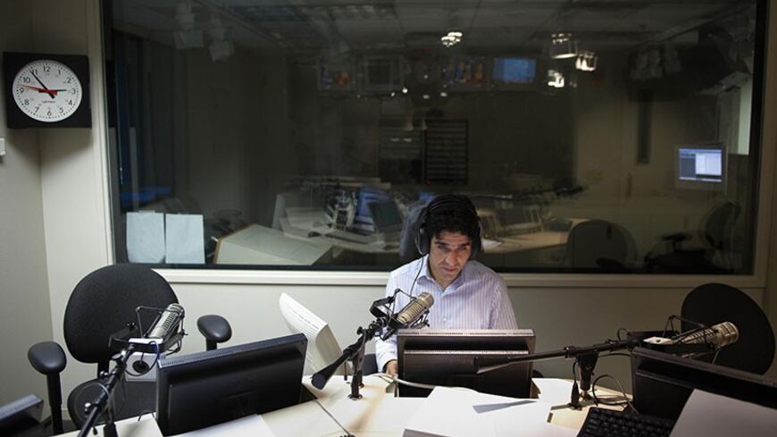 TO GO WITH AFP STORY BY SHAUN TANDON "ENTERTAINMENT-US-AFGHANISTAN-TELEVISION"
Voice Of America (VOA) Afghan Service broadcaster Daoud Sediqi listens to a caller during a show on September 16, 2009 in a studio of the VOA in Washington. Sediqi, the former host of "Afghan Idol", one of Afghanistan's most popular television programs which showcases musical talent, joined the VOA in the US where he was granted asylum to escape Taliban threats.       AFP PHOTO/Mandel NGAN (Photo credit should read MANDEL NGAN/AF
