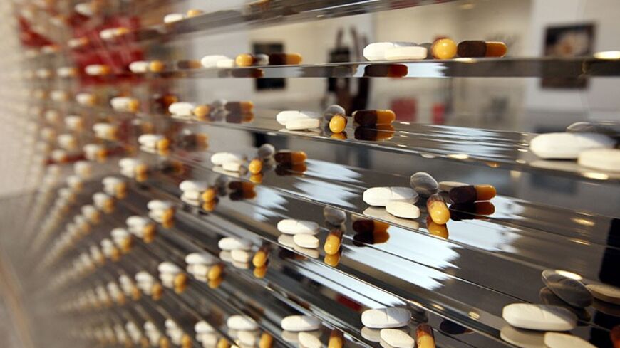 Artist Damien Hirst's 'Where there's a will there's a way,' which shows antiretroviral drugs in a medicine cabinet, is seen as it is displayed at a gallery in New York, February 4, 2008, before the (RED) Auction at Sotheby's to benefit HIV/AIDS relief programs in Africa. The auction, arranged by Bono and Damien Hirst, will be on Valentines Day, February 14.  REUTERS/Chip East  (UNITED STATES) - RTR1WOB4