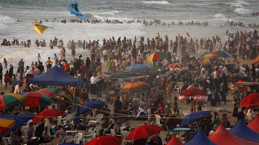 Palestinians enjoy the warm weather on a Gaza City beach June 24, 2011.  REUTERS/Ibraheem Abu Mustafa (GAZA - Tags: SOCIETY ENVIRONMENT) - RTR2O26S
