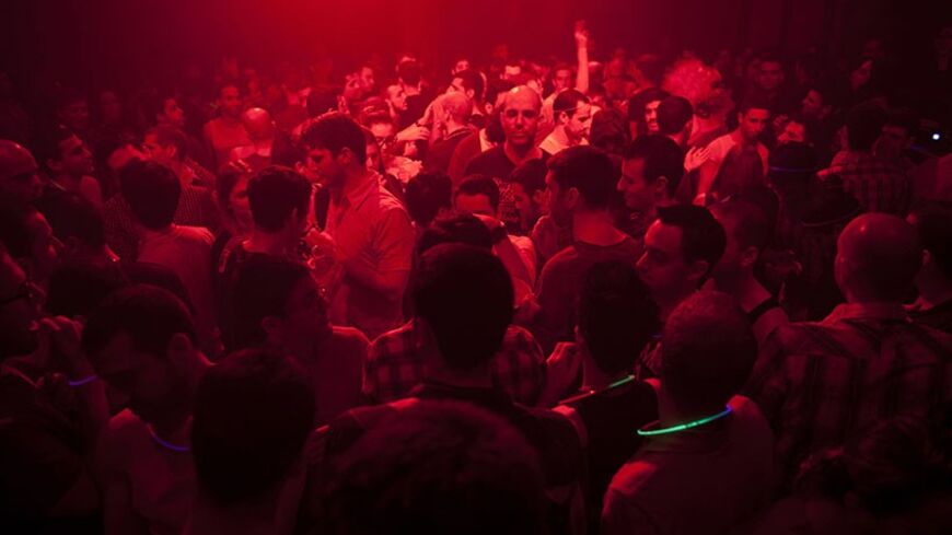 People dance at a gay party in a Tel Aviv night club January 20, 2012. Less than an hour away but a world apart from traditional places of pilgrimage in the Holy Land, Israel's free-wheeling city of Tel Aviv has become a Mediterranean hotspot for gay tourism. Picture taken January 20, 2012. REUTERS/Nir Elias (ISRAEL - Tags: SOCIETY ENTERTAINMENT TRAVEL) - RTR2WRZE