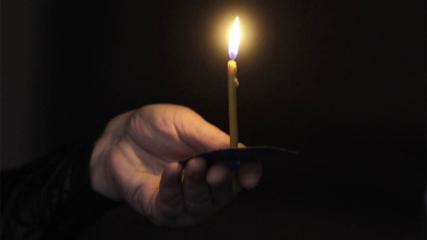 A woman holds a candle during a religious service marking the anniversary of mass killings of Armenians in Ottoman Empire in 1915 at an Armenian church in Tbilisi April 24 2012. Armenia, backed by many historians and parliaments, says about 1.5 million Christian Armenians were killed in what is now eastern Turkey during World War One in a deliberate policy of genocide ordered by the Ottoman government. Successive Turkish governments and the vast majority of Turks feel the charge of genocide is an insult to 