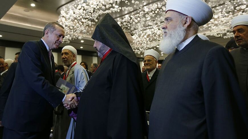 Turkey's Prime Minister Tayyip Erdogan (L) shakes hands with Archbishop Nourhan Manougian, Patriarchal Vicar of the Armenian Patriarchate of Jerusalem, during the international conference on the Arab awakening and peace in the Middle East in Istanbul September 7, 2012. REUTERS/Murad Sezer (TURKEY  - Tags: POLITICS RELIGION) - RTR37MBE