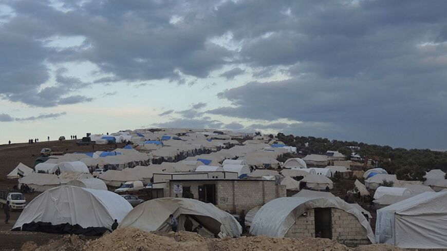 Syrian refugees are seen in a refugee camp on the Syrian side of the border with Turkey, near Idlib January 29, 2013, in this picture provided by Shaam News Network. Picture taken January 29, 2013. REUTERS/Muhammad Najdet Qadour/Shaam News Network/Handout (SYRIA - Tags: POLITICS CIVIL UNREST CONFLICT SOCIETY IMMIGRATION POVERTY) ATTENTION EDITORS - THIS PICTURE WAS PROVIDED BY A THIRD PARTY. REUTERS IS UNABLE TO INDEPENDENTLY VERIFY THE AUTHENTICITY, CONTENT, LOCATION OR DATE OF THIS IMAGE. FOR  EDITORIAL U