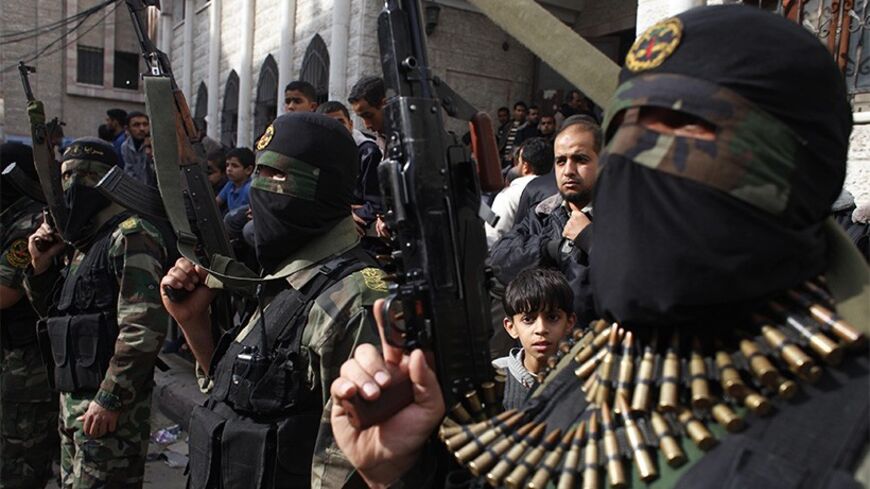 Islamic jihad militants take part in the funeral of three comrades, who were killed in an Israeli air strike, in Khan Younis in the southern Gaza Strip March 11, 2014. An Israeli air strike on Tuesday killed three Palestinian militants in the Gaza Strip, the Islamic Jihad group said. The Israeli military said an Israeli aircraft targeted Islamic Jihad members who had fired a mortar bomb at its forces, and "direct hits were confirmed". REUTERS/Ibraheem Abu Mustafa (GAZA - Tags: POLITICS CIVIL UNREST) - RTR3G