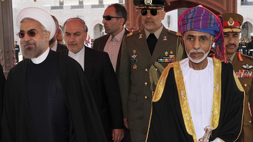 Oman's Sultan Qaboos bin Said (R) walks with Iran's President Hassan Rouhani upon Rouhani's arrival in Muscat March 12, 2014. REUTERS/Sultan Al Hasani (OMAN - Tags: POLITICS ROYALS) - RTR3GQAH