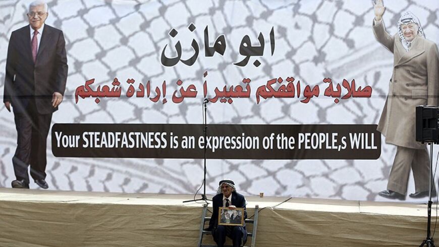 A Palestinian sits in front of a poster depicting Palestinian President Mahmoud Abbas (L) and late Palestinian leader Yasser Arafat during a rally in the West Bank city of Ramallah March 17, 2014. Thousands of Palestinians took to the streets on Monday to show their support for President Mahmoud Abbas, who is under heavy pressure as he prepares to meet U.S. President Barack Obama.
REUTERS/Mohamad Torokman (WEST BANK - Tags: POLITICS CIVIL UNREST) - RTR3HFEM