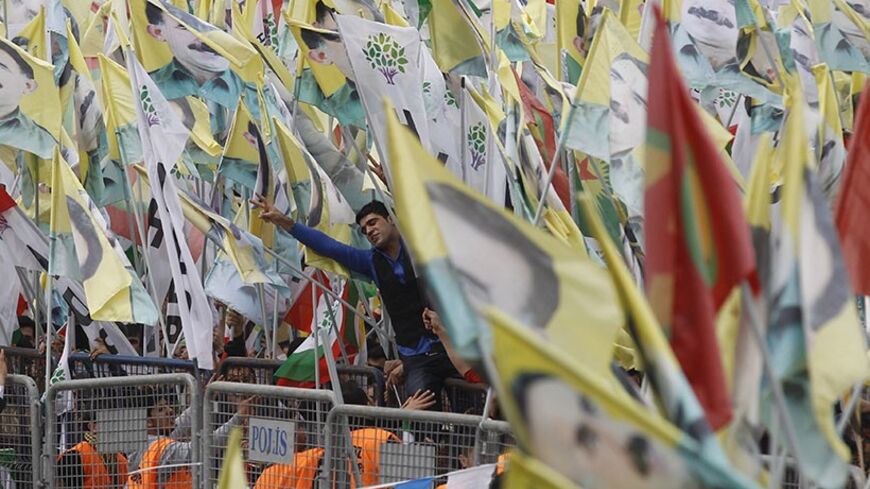 People take part in a gathering to celebrate Newroz, which marks the arrival of spring and the new year in Istanbul March 23, 2014. Jailed Kurdish militant leader Abdullah Ocalan of the Kurdistan Workers Party (PKK) called on the Turkish government on Friday to create a legal framework for their peace talks, whose fate is looking increasingly uncertain a year after he called a ceasefire by his fighters. REUTERS/Osman Orsal (TURKEY - Tags: POLITICS SOCIETY ANNIVERSARY) - RTR3I8YF