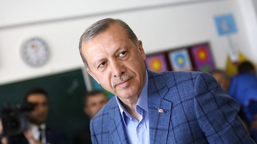 Turkey's Prime Minister Tayyip Erdogan prepares to leave a polling station during the municipal elections in Istanbul March 30, 2014. Erdogan looks set to win Sunday's municipal elections that have become a crisis referendum on his 10-year rule as he tries to ward off graft allegations and stem a stream of damaging security leaks. REUTERS/Murad Sezer (TURKEY  - Tags: POLITICS ELECTIONS)   - RTR3J6VI