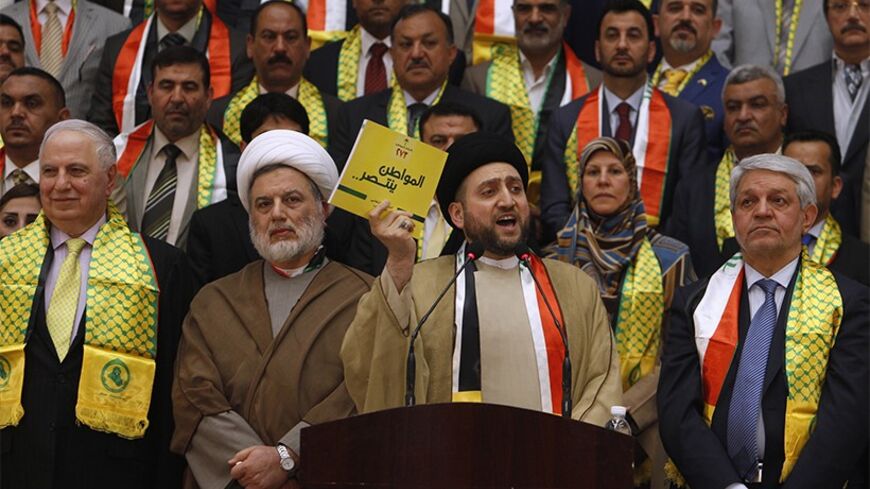 Ammar al-Hakim (C), leader of the Islamic Supreme Council of Iraq, speaks to his supporters during a ceremony held to announce his election platform, in Baghdad April 5, 2014. REUTERS/Ahmed Saad (IRAQ - Tags: POLITICS RELIGION ELECTIONS) - RTR3K2VC