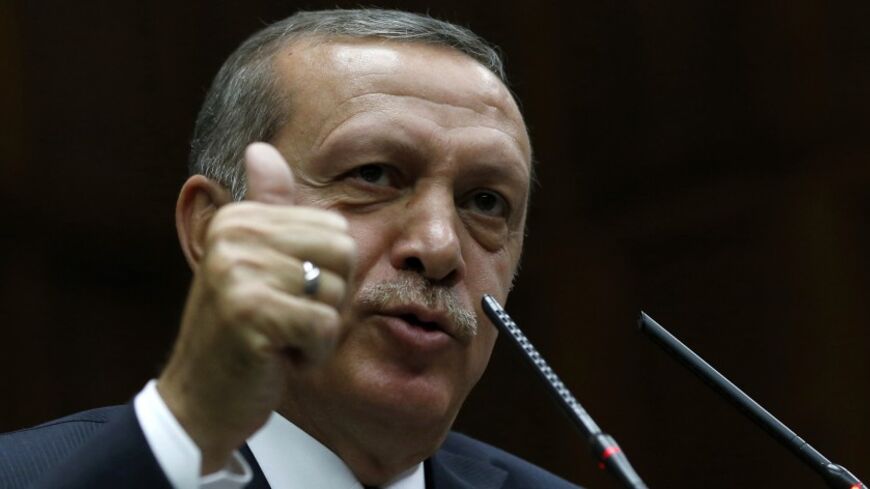 Turkey's Prime Minister Tayyip Erdogan addresses members of parliament from his ruling AK Party (AKP) during a meeting at the Turkish parliament in Ankara April 8, 2014. Turkey's first directly elected president will be a more powerful figure than the current largely ceremonial role, Prime Minister Tayyip Erdogan was quoted on Tuesday as saying, boosting expectations he may run for the post in August. Erdogan is barred by the rules of his ruling AK Party from standing for a fourth term as prime minister and