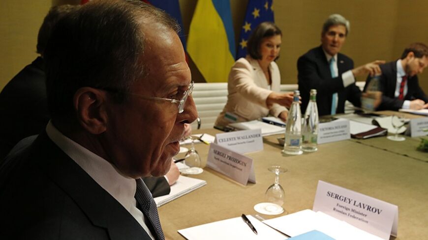 Russia's Foreign Minister Sergei Lavrov (L) looks on as U.S. Secretary of State John Kerry (2nd R) starts a quadrilateral meeting in Geneva, between representatives of the U.S., Ukraine, Russia and the European Union about the ongoing situation in Ukraine April 17, 2014. REUTERS/Jim Bourg (SWITZERLAND - Tags: POLITICS) - RTR3LN59