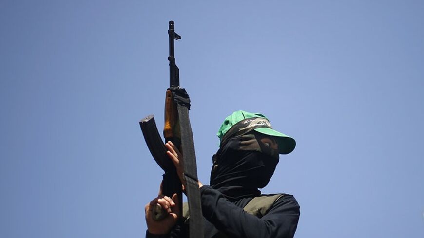 A Hamas militant takes part in a rally marking Palestinian Prisoner Day, in Gaza City April 17, 2014. Israel holds some 5,000 Palestinians it accuses of committing or planning violence against it. REUTERS/Mohammed Salem (GAZA - Tags: POLITICS) - RTR3LNH6