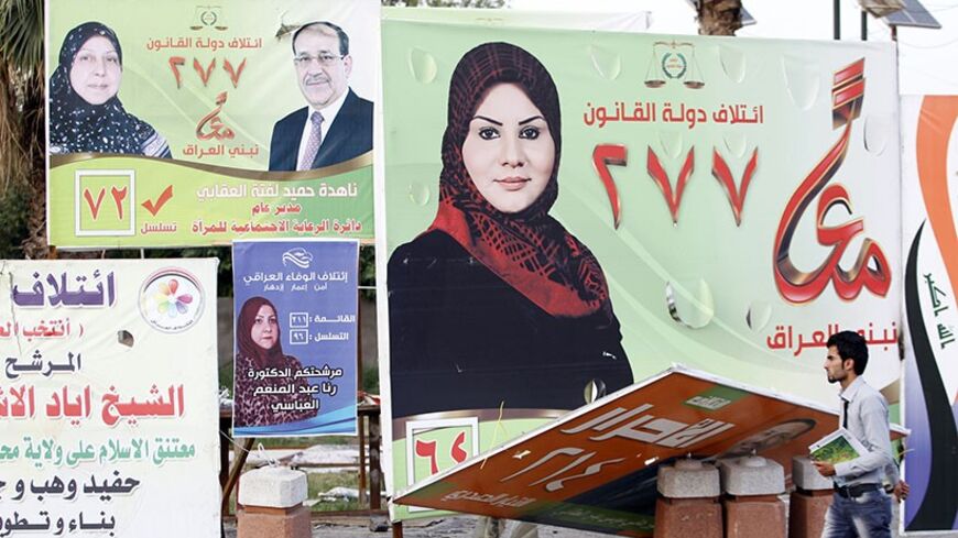 A man walks past election posters of Iraqi women candidates in Baghdad, April 24, 2014.  As Iraq's general election draws closer, both men and women are vying for seats in the country's parliament. But this year's election, the first one after the withdrawal of U.S troops in 2011, has seen an increase in the number of female candidates. According to an Iraqi election official, women make up around 30 to 35 percent of the candidates in the April 30 election. "The total number of nominees in the 2010 parliame
