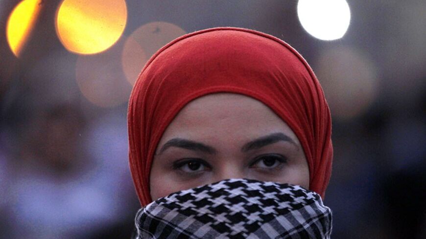 A masked woman demonstrator shouts slogans against Egypt's former army chief Abdel Fattah al-Sisi and against a law restricting demonstrations near El-Thadiya presidential palace in Cairo, April 26, 2014. REUTERS/Amr Abdallah Dalsh (EGYPT - Tags: POLITICS CIVIL UNREST) - RTR3MR49