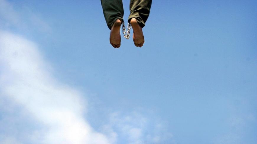 The body of Iranian serial child killer Mohammad Bijeh hangs in the town of Pakdasht, south of Tehran March 16, 2005. Dubbed the 'vampire of the Tehran desert' by local media, Bijeh was sentenced to death for killing 17 children, most of them young boys he raped first, and three adults. He began to prey on children more than two years ago but the killings did not come to light because many victims were from illegal refugee families from neighbouring Afghanistan who were afraid to come forward. Pictures of t