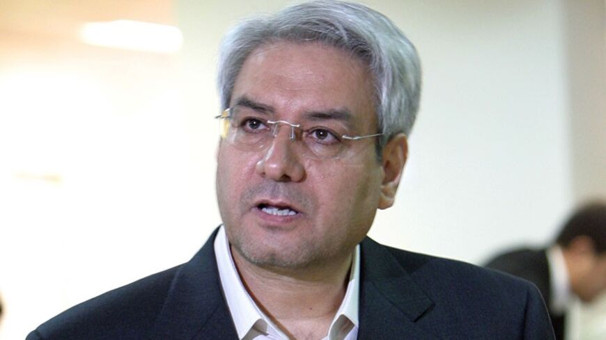 Iranian reformist Ebrahim Asgharzadeh prepares his paperwork to register as a presidential candidate at the Interior Ministry in Tehran.  Iranian reformist Ebrahim Asgharzadeh prepares his paperwork to register as a presidential candidate at the Interior Ministry in Tehran May 14,2005. Candidates began registering on May 10 for Iran's June 17 presidential election. REUTERS/Raheb Homavandi - RTRB4PM