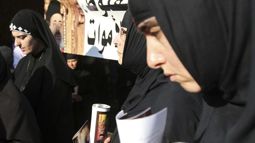 Nuns hold candles during a candle-lit vigil at the Balamand Monastery in Koura, near the north Lebanese city of Tripoli, to call for the release of bishops kidnapped in northern Syria two months ago, June 22, 2013. Greek Orthodox Patriarch John Yazigi led the candle-lit vigil on Saturday for Greek Orthodox archbishop Paul Yazigi and Syriac Orthodox archbishop Yohanna Ibrahim, appealing to their kidnappers to free them and urging Syrian security forces to do more to win their release. REUTERS/Omar Ibrahim (L