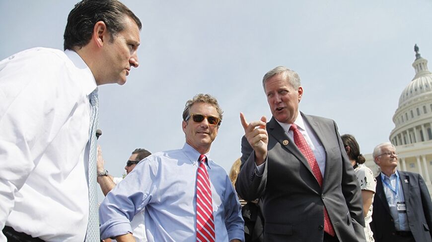 (L-R) U.S. Senator Ted Cruz (R-TX), Senator Rand Paul (R-KY) and Representative Mark Meadows (R-NC) chat as they arrive to speak at the Tea Party Patriots 'Exempt America from Obamacare' rally on the west lawn of the U.S. Capitol in Washington, September 10, 2013. REUTERS/Jonathan Ernst (UNITED STATES - Tags: POLITICS HEALTH CIVIL UNREST) - RTX13G43