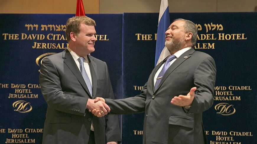 Israel's Foreign Minister Avigdor Lieberman (R) greets his Canadian counterpart John Baird before their dinner in Jerusalem January 19, 2013. Canadian Prime Minister Stephen Harper is on a four-day visit to Israel and the Palestinian Territories. REUTERS/Darren Whiteside (JERUSALEM - Tags: POLITICS) - RTX17LHJ