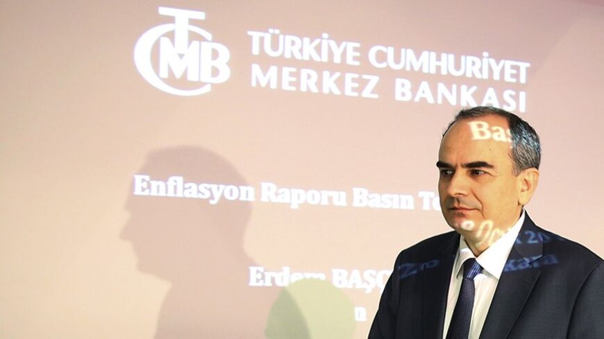 Turkey's Central Bank Governor Erdem Basci arrives at a news conference in Ankara January 28, 2014. Turkey's central bank will use all instruments at its disposal at an extraordinary policy meeting later on Tuesday in a bid to prevent a deterioration in inflation, Basci said on Tuesday. REUTERS/Umit Bektas (TURKEY - Tags: POLITICS BUSINESS) - RTX17XXE