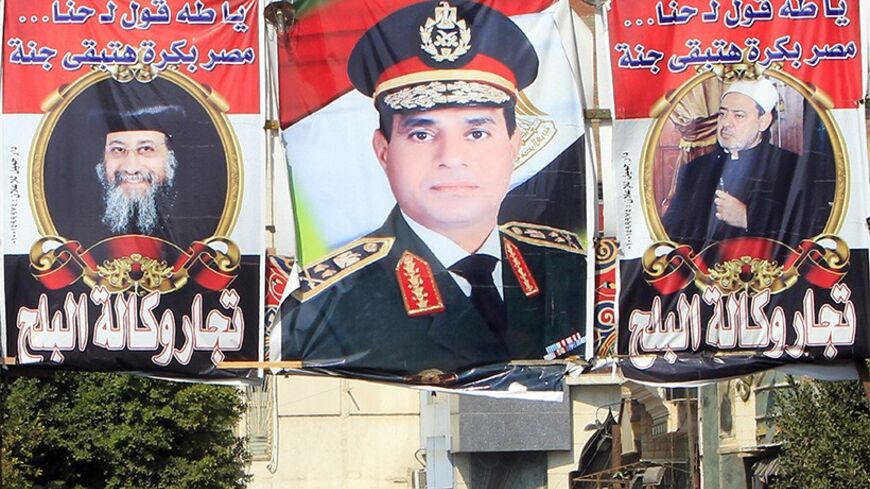 People walk near banners of Egypt's army chief, Field Marshal Abdel Fattah al-Sisi (C), with Coptic and Islamic leaders Grand Sheikh of Al-Azhar Ahmed al-Tayeb (R) and Pope Tawadros II (L) of the Coptic Orthodox Church in Cairo February 19, 2014. Sisi, won vast popularity by crushing the Muslim Brotherhood, but even a man seen by his followers as invincible may be unable to fix the mess in the politically sensitive energy sector. Sisi, who toppled Islamist leader Mohamed Mursi in July and promised to bring