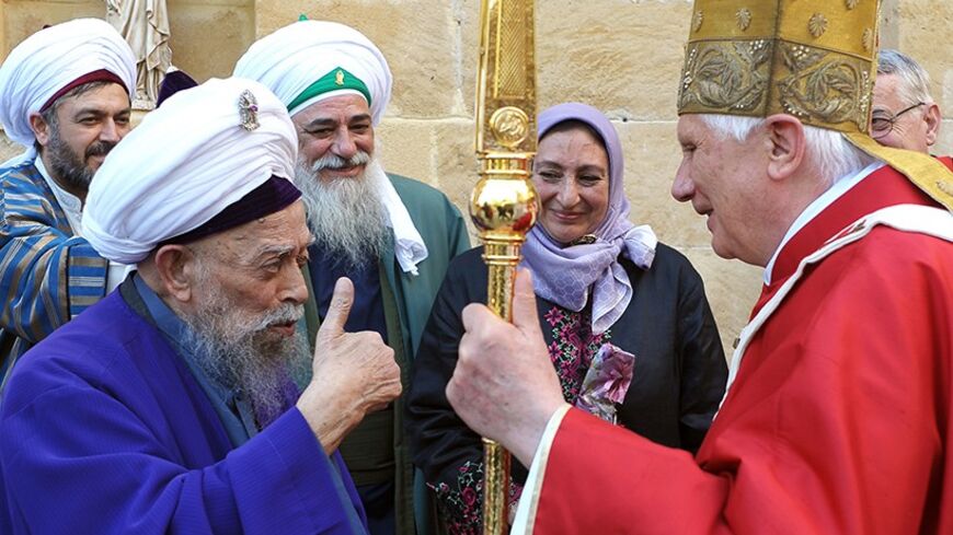 In this handout picture released by the Vatican press office, Pope Benedict XVI meets with Sufi mystic Sheikh Nazim Haqqani (L), who travelled from the north of the divided island of Cyprus, to see him at the Latin Church of the Holy Cross in Nicosia on June 5, 2010, the second day of the pontiff's visit to the mainly Greek Orthodox east Mediterranean island. AFP PHOTO / POOL / OSSERVATORE ROMANO -- RESTRICTED TO EDITORIAL USE -- (Photo credit should read --/AFP/Getty Images)