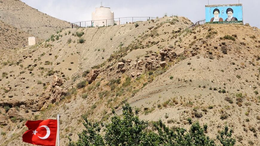 Supreme leaders of Iran, the late Ayatollah Ruhollah Khomeini (L) and  Ayatollah Ali Khameni (R), are seen on the top of a hill from the Turkish side of the border near the Esendere crossing between Turkey and Iran on June 25, 2012 in Yuksekova, a district of the Turkish province of Hakkari.             AFP PHOTO/BULENT KILIC        (Photo credit should read BULENT KILIC/AFP/GettyImages)