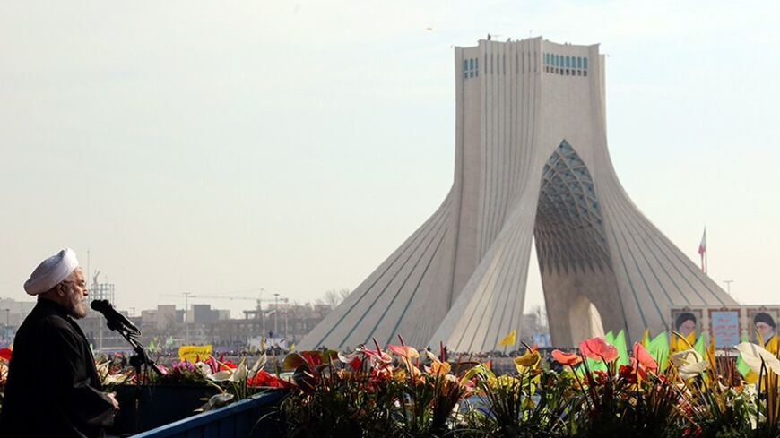 Iranian President Hassan Rouhani waves as he delivers a speech during a rally in Tehran's Azadi Square (Freedom Square) to mark the 35th anniversary of the Islamic revolution on February 11, 2014. The 35th anniversary of the revolution that ousted the US-backed shah, comes as Tehran rides the wave of a landmark nuclear deal with major powers. AFP PHOTO/ATTA KENARE        (Photo credit should read ATTA KENARE/AFP/Getty Images)