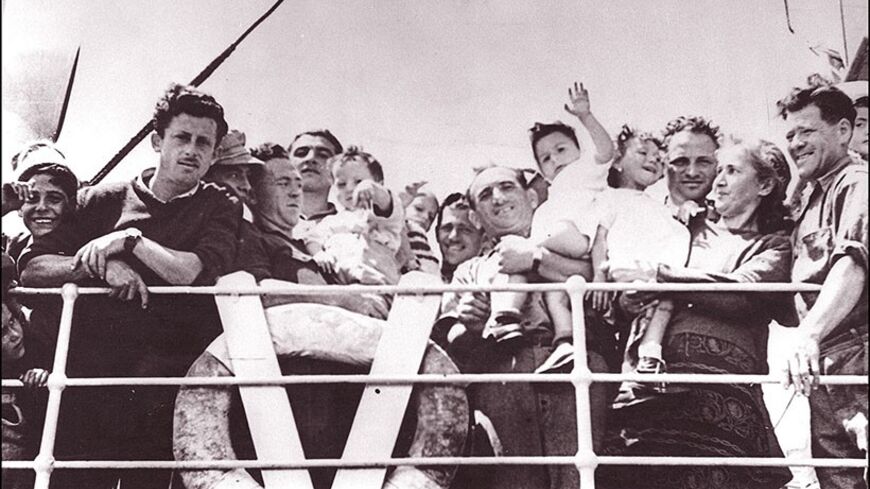 TEL-AVIV, ISRAEL: The crowd of Jewish immigrants waving from the deck of trawler "Andria" as they arrive 20 May 1948 at Tel Aviv harbor. Israel was founded on 14 May 1948 by the Jewish National Council and was recognized by the United States and the Soviet Union 15 and 17 May. (Photo credit should read AFP/Getty Images)