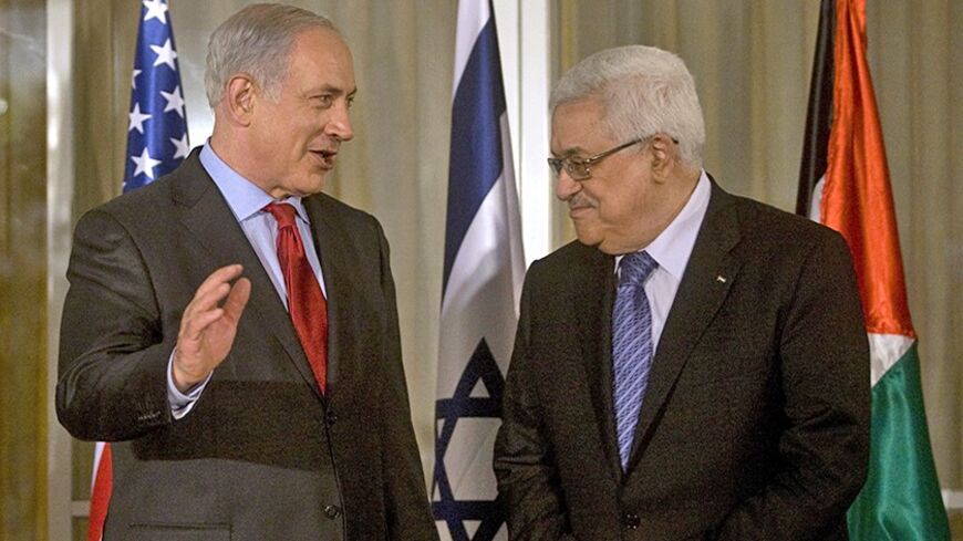 Israel's Prime Minister Benjamin Netanyahu (L) stands with Palestinian President Mahmoud Abbas before their meeting in Jerusalem September 15, 2010. Clinton warmly endorsed Israeli and Palestinian leaders on Wednesday ahead of negotiations to try to break a deadlock over Jewish settlement building in the occupied West Bank. REUTERS/Lior Mizrahi/Pool (JERUSALEM - Tags: POLITICS) - RTR2IDB7