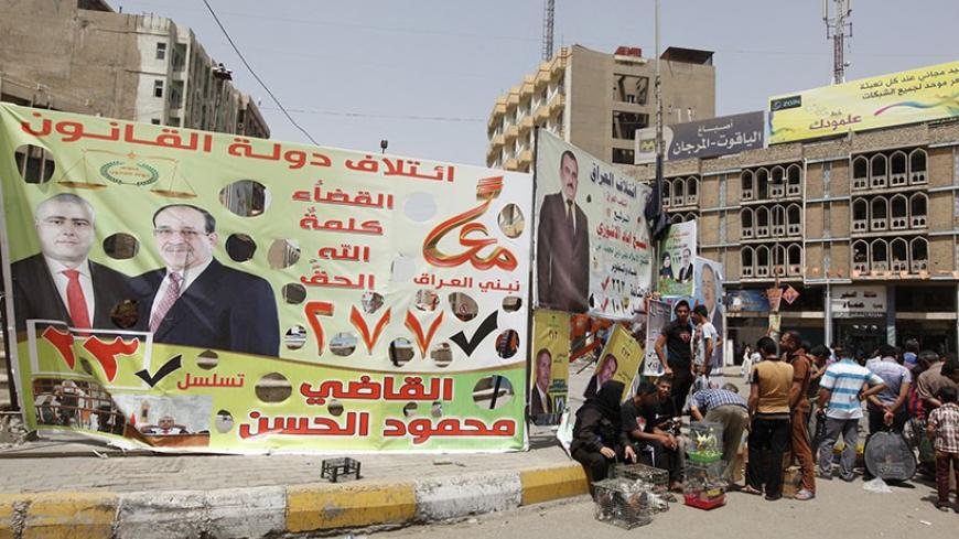 An election poster of Mahmoud Al-Hassan of Prime Minister Nuri al-Maliki's State of Law coalition is displayed along a street at the start of the election campaign in Baghdad April 18, 2014. Iraq is holding its national election at the end of this month. REUTERS/Ahmed Saad (IRAQ - Tags: POLITICS ELECTIONS) - RTR3LSZ3