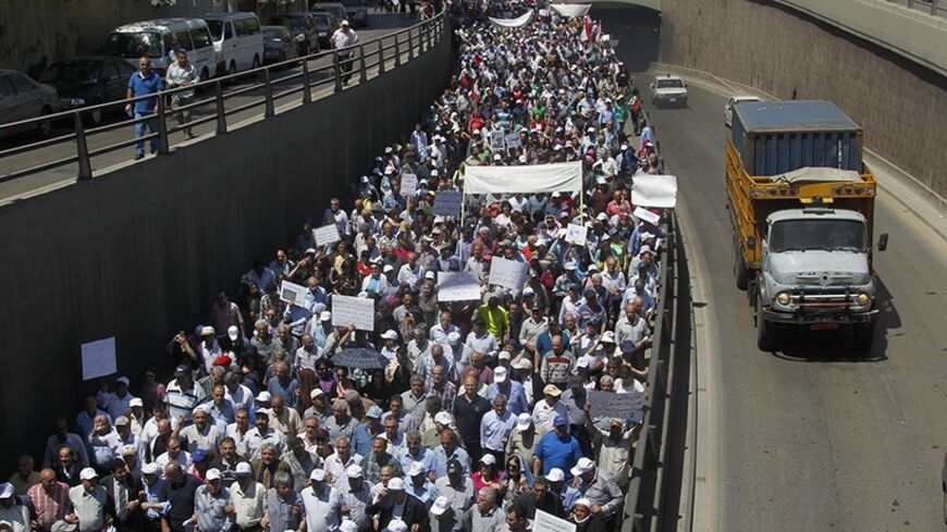 Thousands of Lebanon's public sector employees march through Beirut to demand the parliament to approve a new salary scale law which if passed means a significant wages increase, April 29, 2014. The Union Coordination Committee (UCC) kicked off its demonstration on Tuesday from the Lebanese Central Bank in Hamra towards the Chamber of Trade and Commerce in Sanayeh. The demonstrators called on the Central Bank Governor and concerned sides to meet their demands, the National News Agency (NNA) reported. REUTE