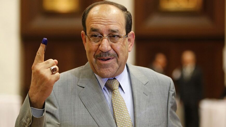 Iraq's Prime Minister Nuri al-Maliki shows his ink marked finger as he votes during parliamentary election in Baghdad April 30, 2014. Iraqis head to the polls on Wednesday in their first national election since U.S. forces withdrew from Iraq in 2011 as Prime Minister Nuri Maliki seeks a third term amid rising violence.
REUTERS/Ahmed Jadallah (IRAQ - Tags: ELECTIONS POLITICS TPX IMAGES OF THE DAY) - RTR3N6JL
