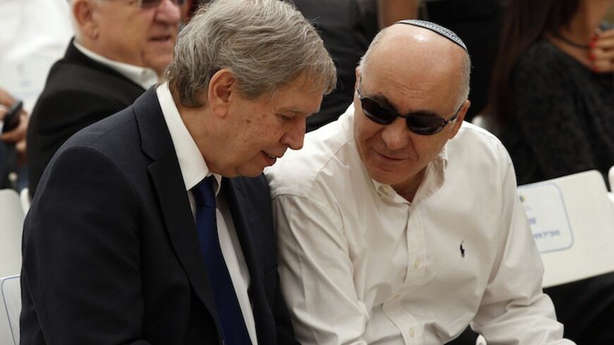 Tamir Pardo (L), head of Israel's spy agency Mossad, and Yoram Cohen, chief of Israel's Shin Bet internal security service, speak during a corner-stone laying ceremony for a memorial commemorating fallen soldiers on Mount Herzl military cemetery in Jerusalem April 30, 2014.  REUTERS/Ronen Zvulun (JERUSALEM - Tags: POLITICS) - RTR3N968