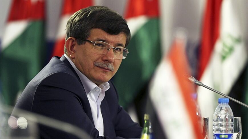 Turkish Foreign Minister Ahmet Davutoglu attends the opening of a meeting of foreign ministers at the Zaatari refugee camp in the Jordanian city of Mafraq, near the border with Syria, May 4, 2014. Foreign ministers of major refugee hosting countries attended a one-day meeting in the Zaatari refugee camp to discuss a resolution for the Syrian refugee crisis. The meeting - the third for countries harbouring the largest number of Syrian refugees - brought together Foreign Ministers from Jordan, Lebanon, Egypt,
