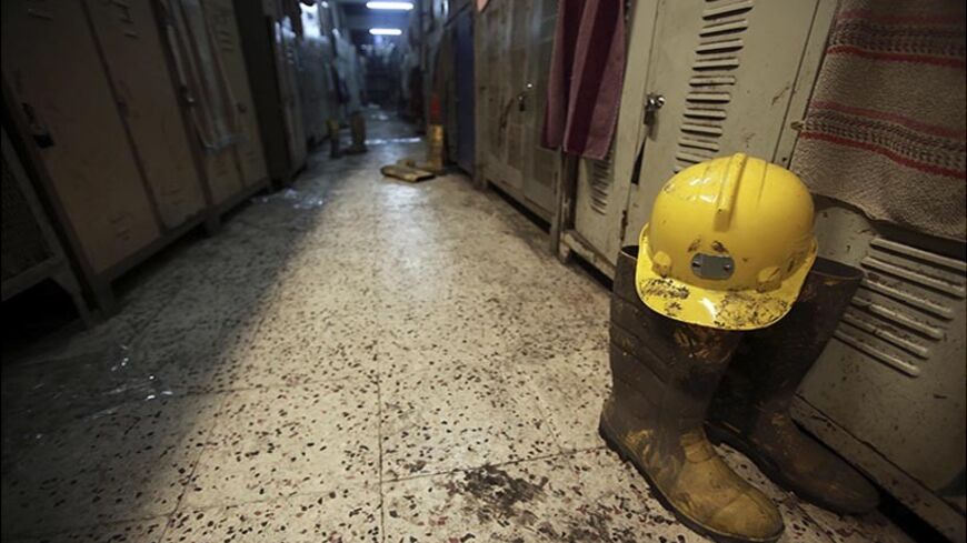 A boot and a helmet are seen in a changing room used by coal miners after a mining disaster in Soma, a district in Turkey's western province of Manisa May 14, 2014. Rescuers were still trying to reach parts of the coal mine in Soma, 480 km (300 miles) southwest of Istanbul, almost 48 hours after fire knocked out power and shut down the ventilation shafts and elevators, trapping hundreds underground. At least 282 people have been confirmed dead, mostly from carbon monoxide poisoning, and hopes are fading of 