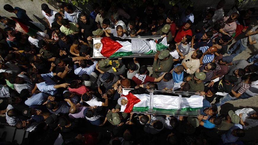 ATTENTION EDITORS - VISUAL COVERAGE OF SCENES OF INJURY OR DEATH
Mourners carry the bodies of two Palestinians, who were shot dead by Israeli forces on Thursday, during their funeral in the West Bank city of Ramallah May 16, 2014. Israeli forces shot dead the two Palestinians during a stone-throwing protest on Thursday to mark the "Nakba", or "catastrophe", as Palestinians term their displacement when Israel was founded. REUTERS/Mohamad Torokman (WEST BANK - Tags: POLITICS) TEMPLATE OUT - RTR3PGKE