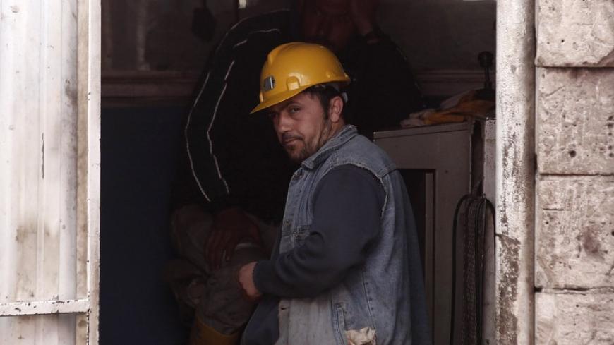 A miner waits in front of the coal mine in Soma, a district in Turkey's western province of Manisa, after a coal mine explosion, May 17, 2014.  Rescue workers began winding up their operations on Saturday after finding the bodies of two more miners, believed to be the last remaining in the mine, bringing the death toll in Turkey's worst industrial disaster to 301, the energy minister said.  REUTERS/ Osman Orsal (TURKEY - Tags: DISASTER ENERGY) - RTR3PKPJ