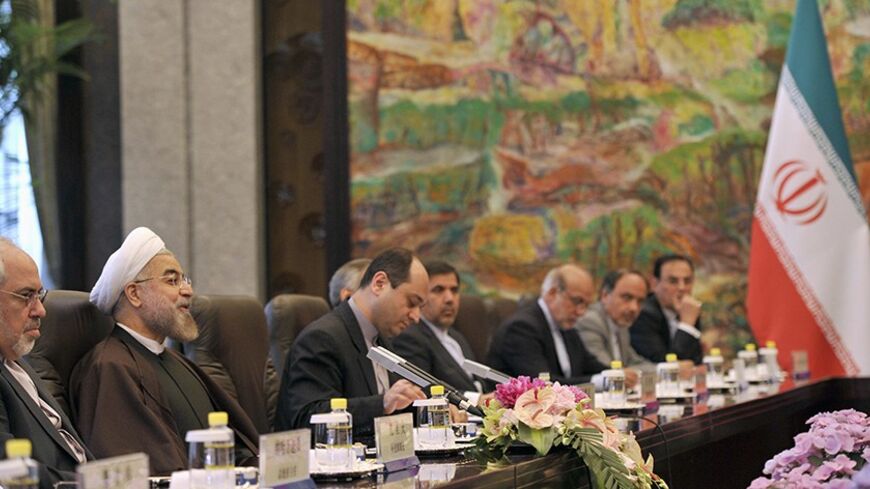 Iranian President Hassan Rouhani (2nd L) and Chinese President Xi Jinping (not pictured) attend a meeting at the Xijiao State Guesthouse in Shanghai, May 22, 2014. REUTERS/Kenzaburo Fukuhara/Pool (CHINA - Tags: POLITICS) - RTR3QALE