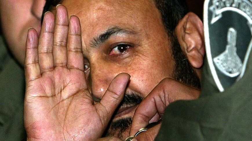 Marwan Barghouthi (C) waves as he enters Tel Aviv's District court
December 12, 2002. A Tel Aviv District Court on Thursday upheld
Israel's right to arrest and try Palestinian uprising leader Marwan
Barghouthi on charges that he masterminded deadly attacks on Israeli
civilians. REUTERS/Pool/Sven Nackstrand

OP/ - RTRF4V7