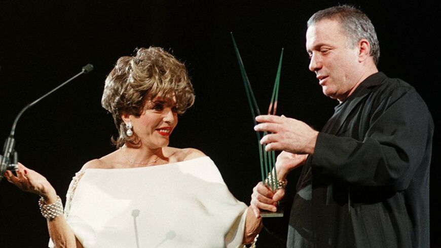 Israeli film director Assi Dayan recieves his trophy from actress Joan Collins during the closing ceremony of the XIX Mediterranean Film Festival in Valencia October 20. Dayan was awarded the maximum prize of the festival, the Golden Palm, for his film "The 92 minutes of Mister Baum".
ES/AA - RTRIKQQ