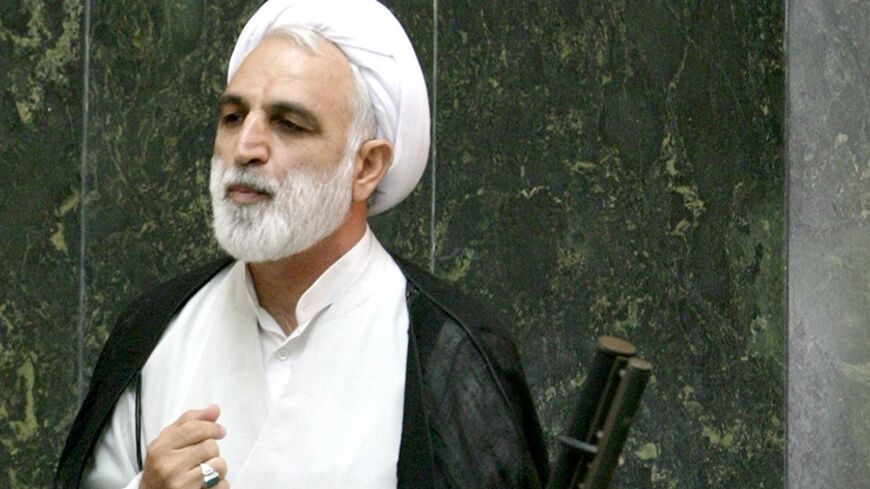 Iranian nominee for intelligence minister, Ghlamhossin Mohseni Ejei (below) speaks to lawmakers as parliament speaker Gholamali Haddadadel looks on in Iranian parliament in Tehran August 22, 2005. Ahmadinejad on Sunday recommended his chosen cabinet to potentially hostile parliamentarians who must approve his selections. REUTERS/Raheb Homavandi  RH/TW - RTRL9BK